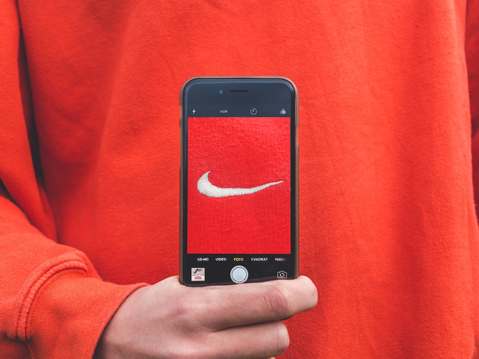 Photo of red-orange Nike logo against shirt