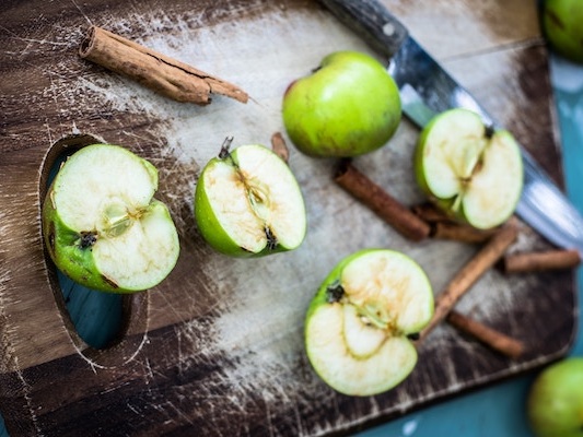 Cinnamon and Apples on wooden board